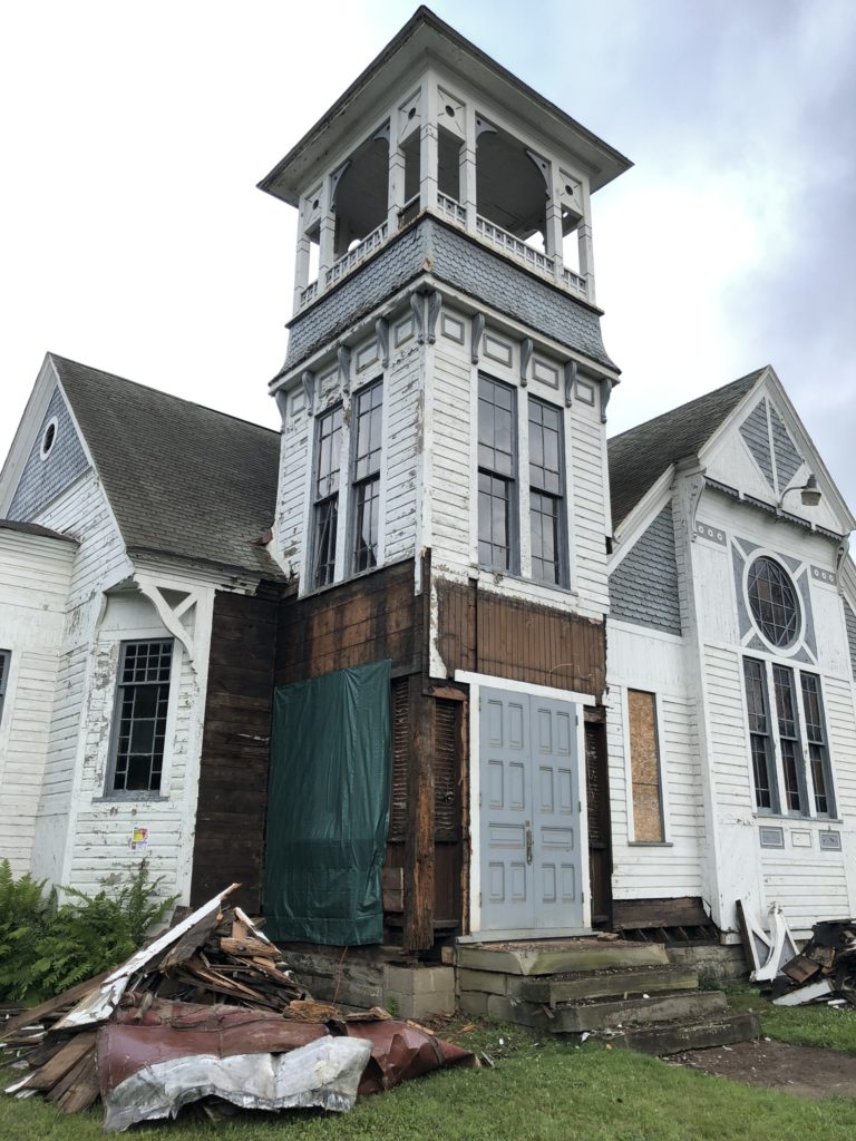 Shows Church tower under reconstruction with some sidi removed July 2019